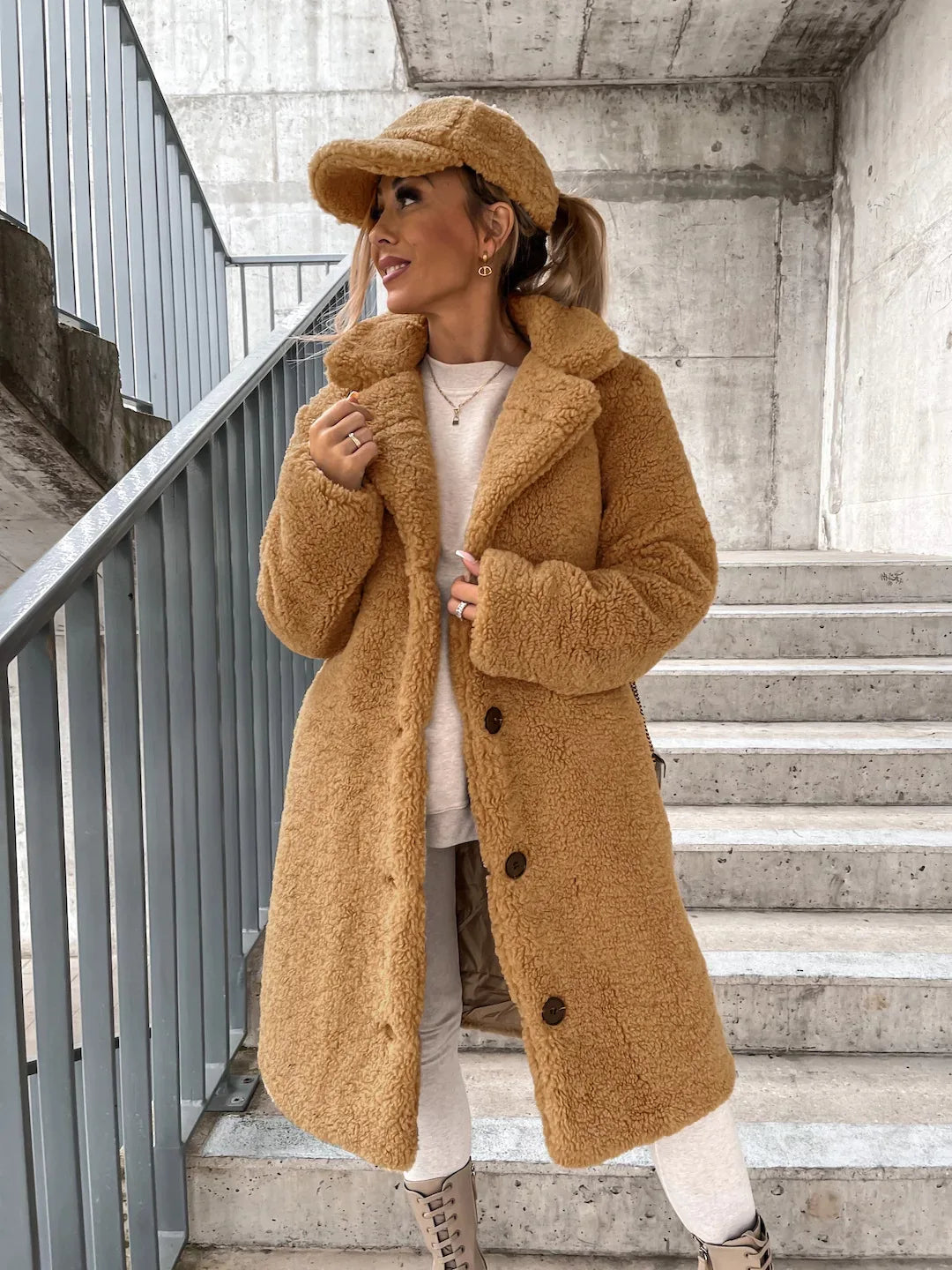 Long women's fall and winter coat by Corporación Turística in apricot, featuring a stylish and warm outerwear design.