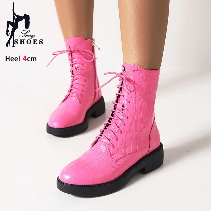 Women's black leather ankle boots with side zipper from Corporación Turística, featuring sleek design and pointed toe.