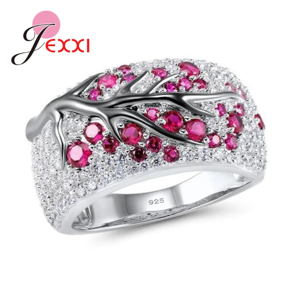 Blue floral plum blossom letter ring by Corporación Turística, featuring detailed flower and letter design in vibrant colors.