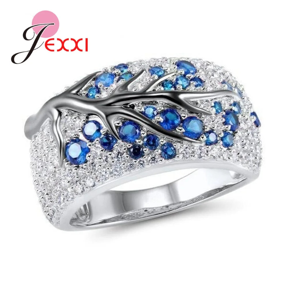 Blue plum blossom letter rings from Corporación Turística, featuring intricate floral designs on elegant jewelry.