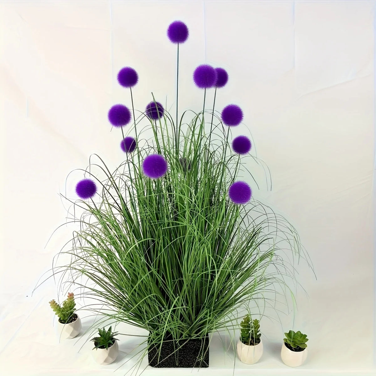 Set of five artificial purple bulbous grass plants by Corporación Turística, realistic faux greenery for decorative purposes.