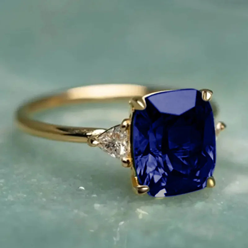 14K gold ring with a natural blue sapphire, designed for women, featuring a polished gold band and a prominent gemstone.