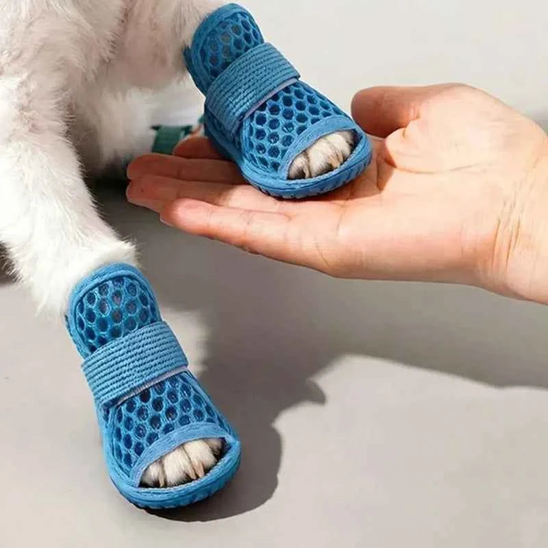 Four pairs of breathable mesh dog shoes in blue, designed for small dogs, from Corporación Turística.