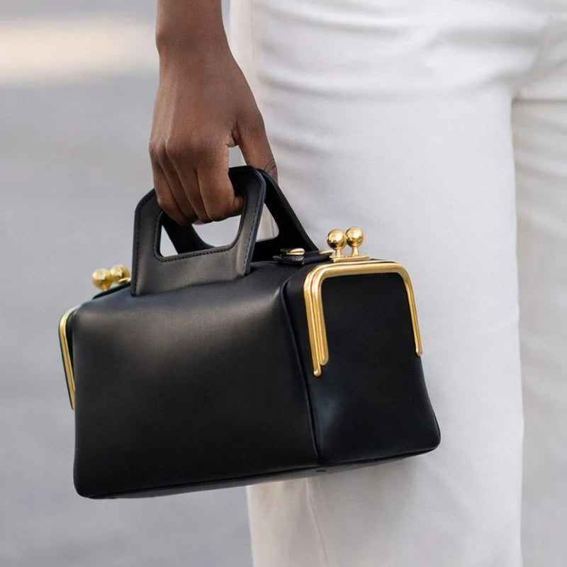 Blue PU shoulder bag with frame clasp design from Corporación Turística, featuring a sleek, modern look and structured style.