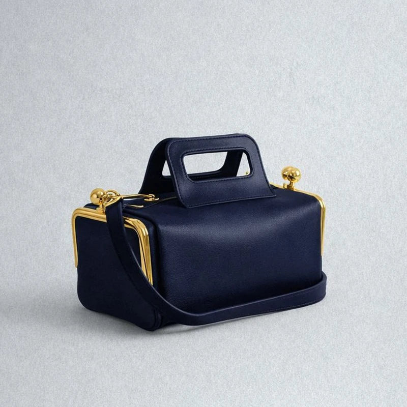 Blue PU shoulder bag with a frame clasp design, stylish and spacious, by Corporación Turística.