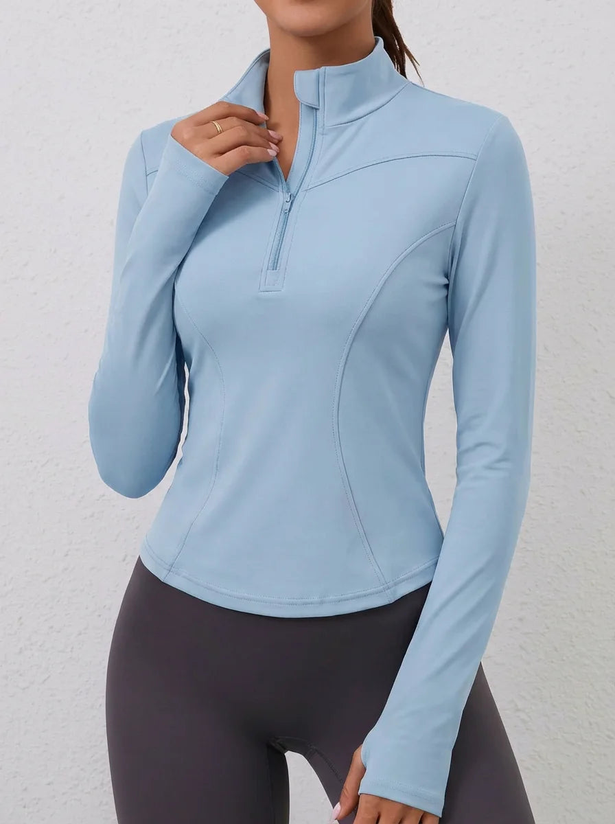 Blue women's fitted yoga sports t-shirt with long sleeves from Corporación Turística, ideal for active wear and yoga practice.