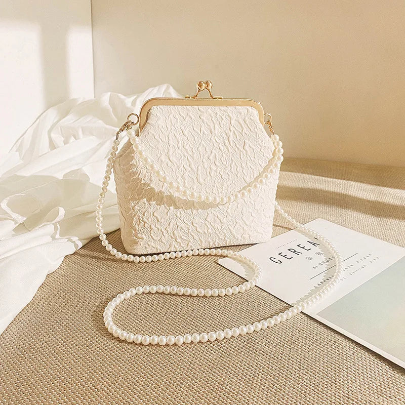 Beige crossbody phone bag with chain strap by Corporación Turística, compact design perfect for carrying mobile devices and essentials.