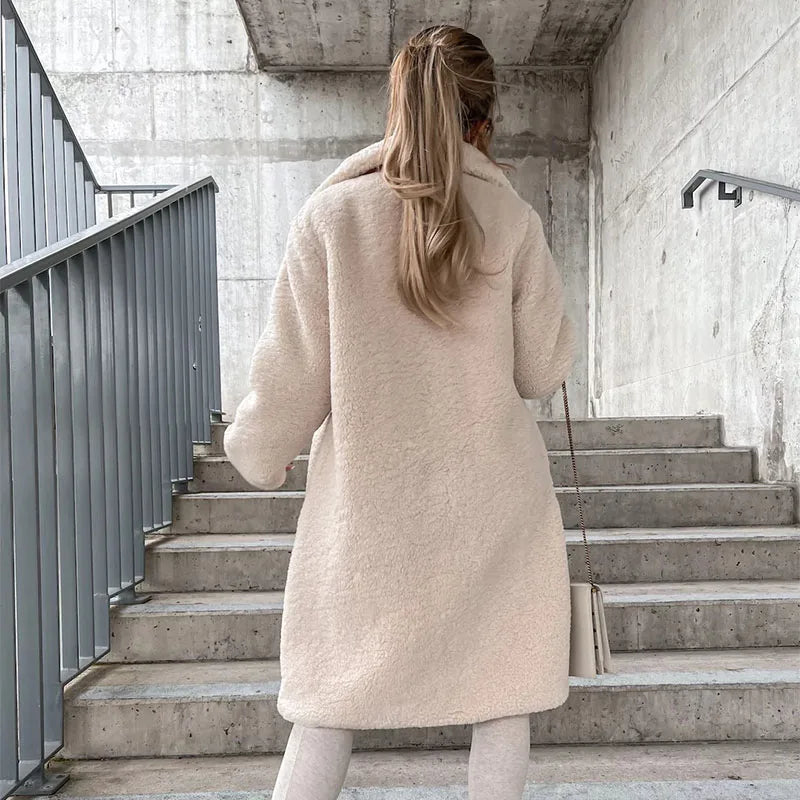 Beige long casual winter coat by Corporación Turística, loose fit, soft, thick, warm, and cozy for cold weather.