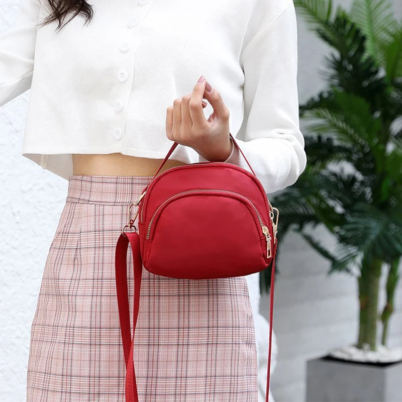 Red versatile and modern shoulder bag for men and women by Corporación Turística, with a sleek design and adjustable strap.