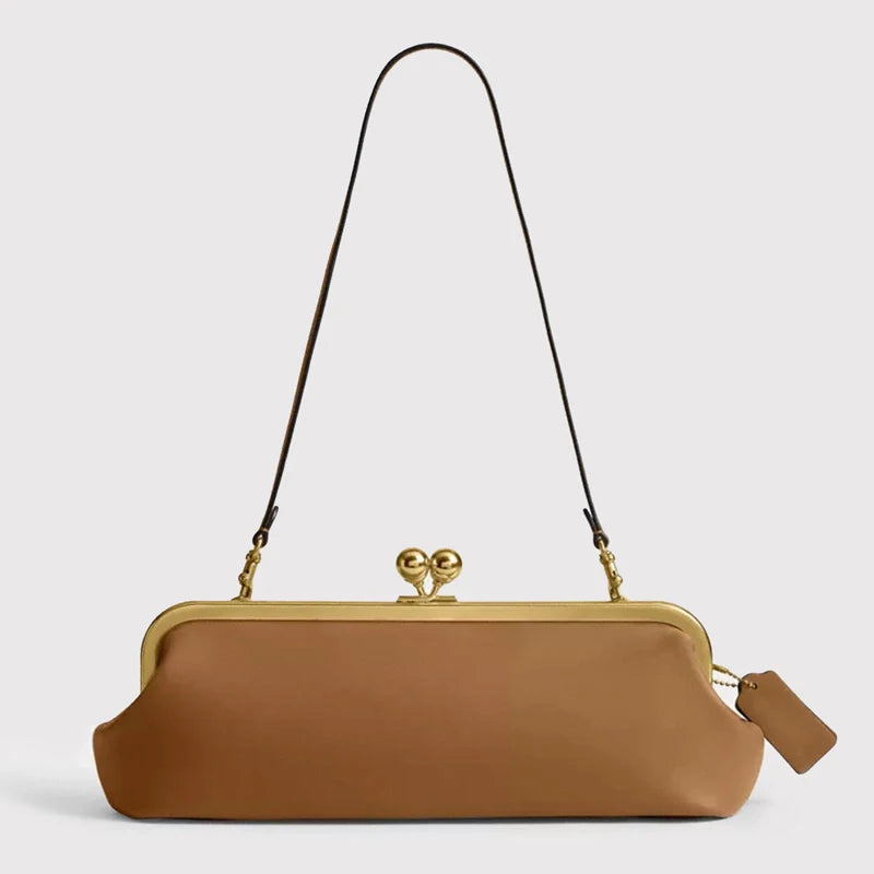 Black classic women's clutch bag with kiss-lock closure, 30 cm long, by Corporación Turística, shown with a sleek, elegant design.