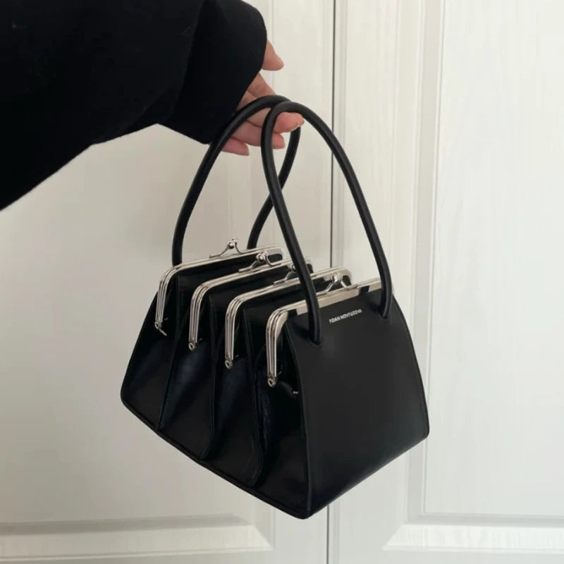 Black multilayer clutch handbag with shell clip details, 22cm by 19cm by 12cm, designed for women.
