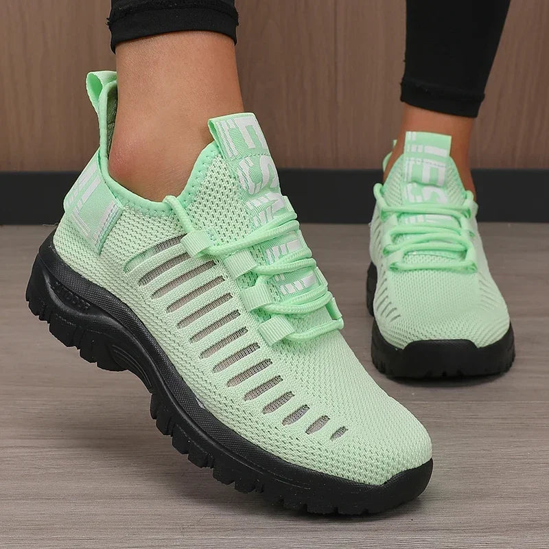 Black men's running shoes from Corporación Turística with breathable mesh upper and sporty design for active wear.