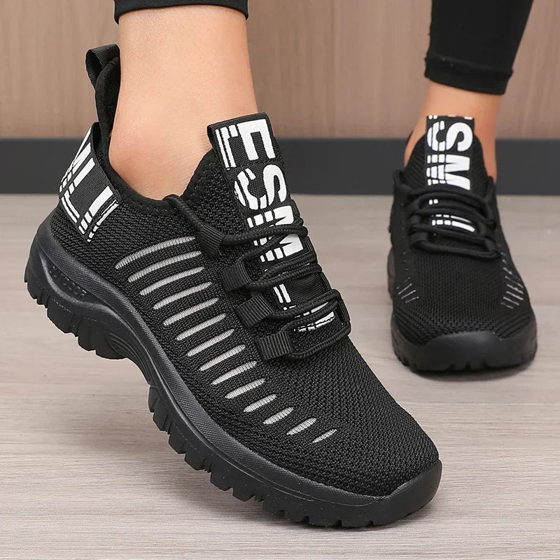 Black men's 2025 fashion running shoes by Corporación Turística with breathable mesh design and sporty style.