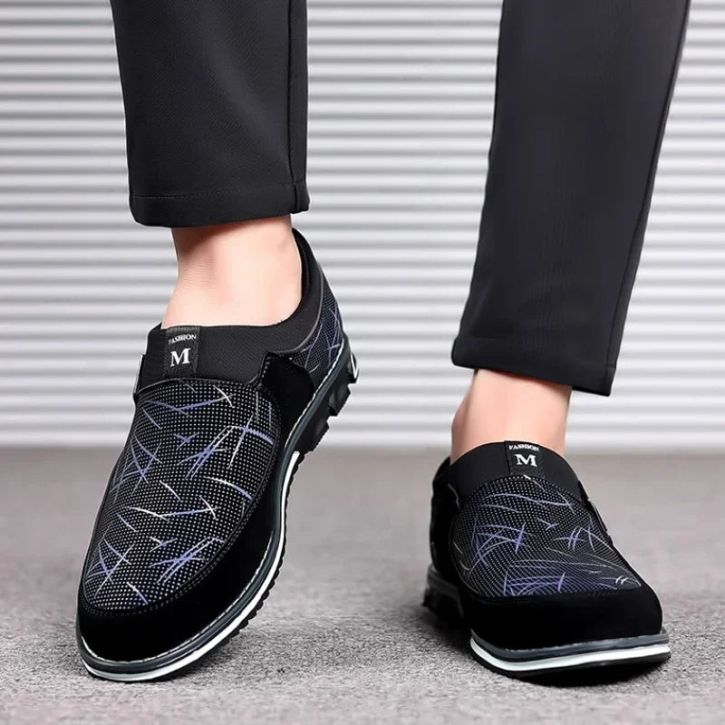 Luxury black leather men's loafers by Corporación Turística, slip-on moccasins with sleek, polished design for formal wear.