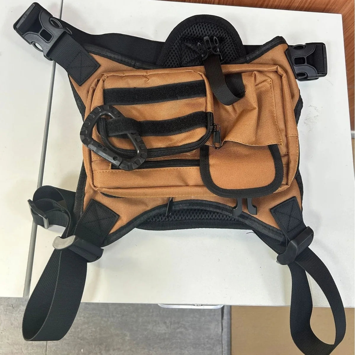 Black men's outdoor chest bag by Corporación Turística, featuring adjustable straps and multiple compartments for outdoor activities.