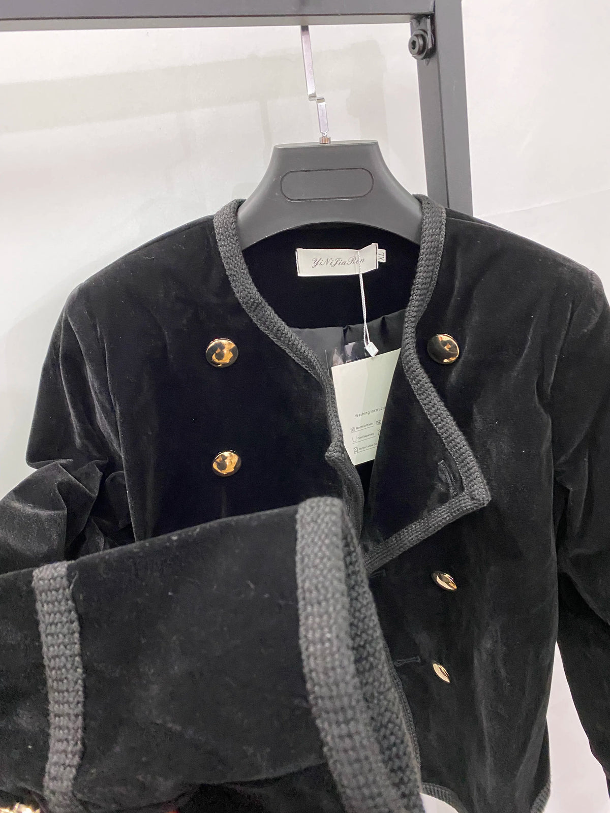 Black women's short jacket from Corporación Turística, stylish autumn-winter coat for casual or dressy wear.