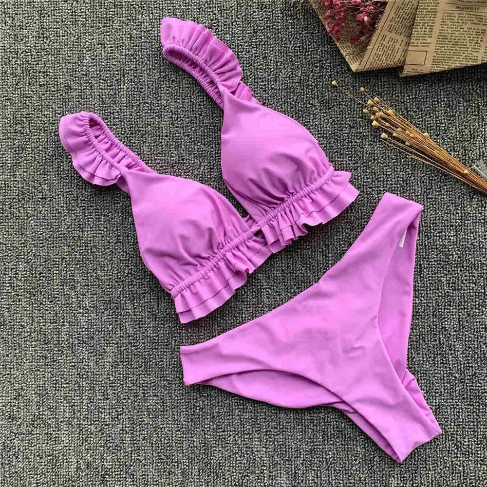Black women's bikini swimsuit with ruffle details, stylish swimwear from Corporación Turística for 2026.