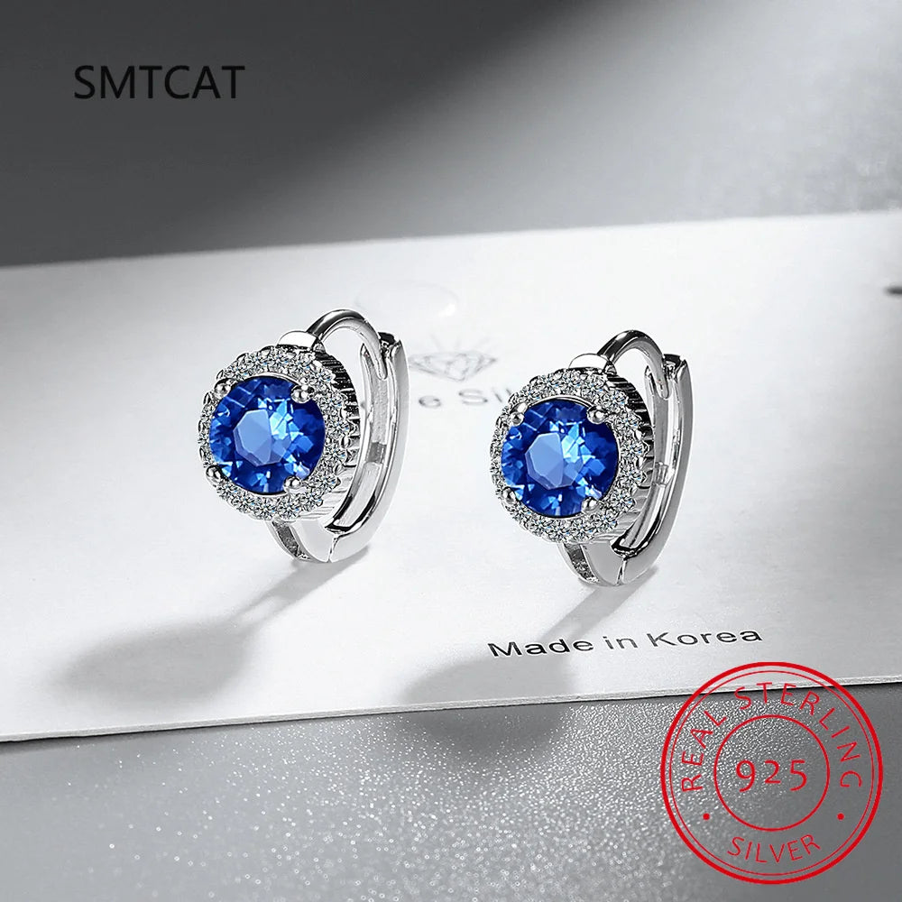Sterling silver 925 hoop earrings with blue sapphire accents, featuring elegant and polished design for stylish wear.