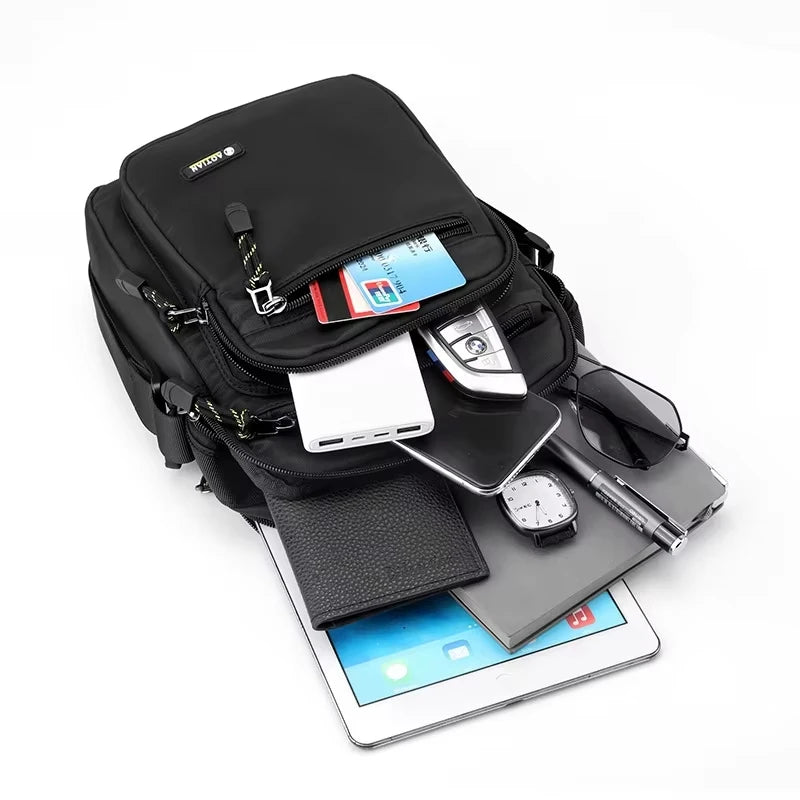 Black men's shoulder bag for camping and hiking by Corporación Turística, showing the bag's front view with adjustable strap and outdoor setting.