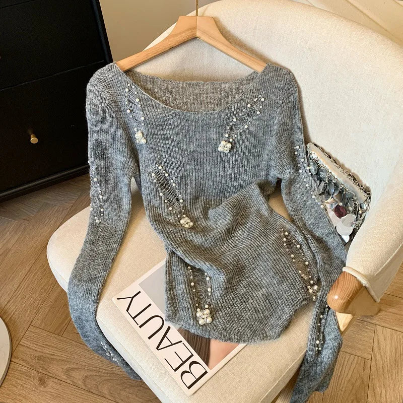 Black women's sweater with open-knit design and beaded holes, stylish and cozy, by Corporación Turística.
