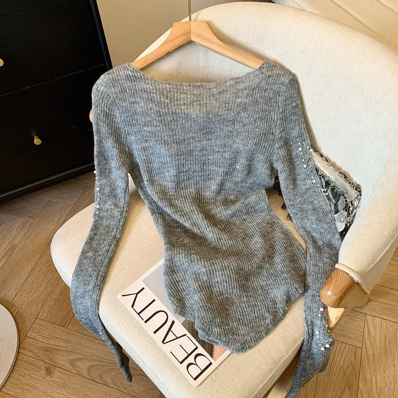Black women's sweater with hollow and beaded hole design, stylish knitwear by Corporación Turística.