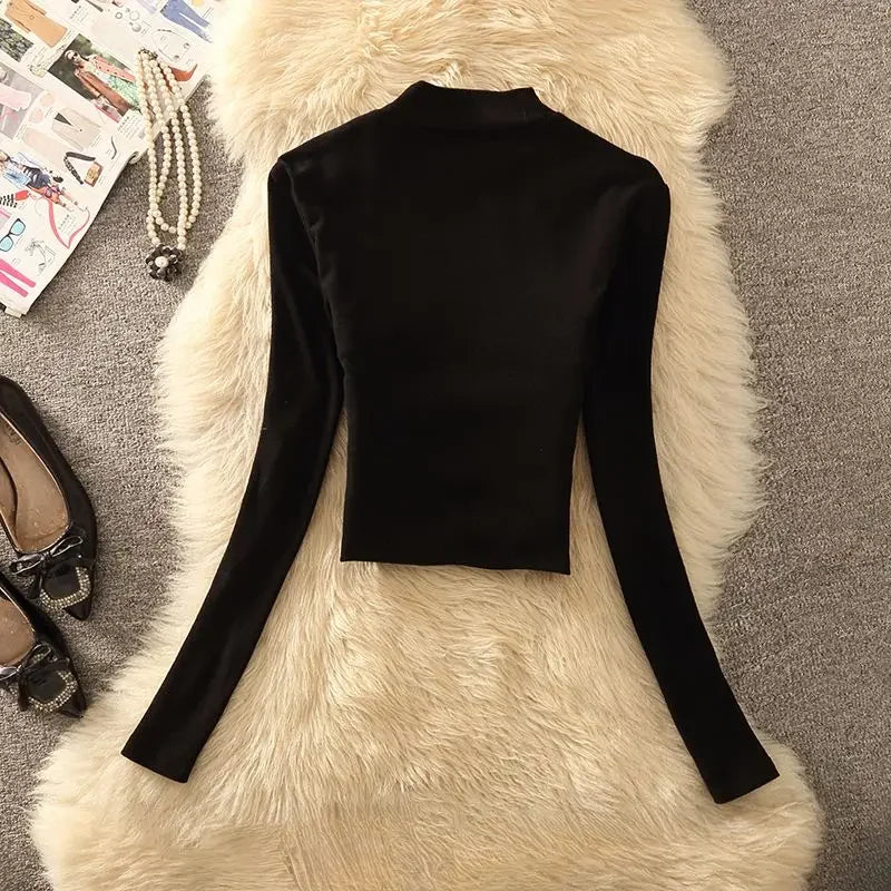 Elegant black long-sleeve turtleneck top for women, from Corporación Turística, featuring a unique high collar and fitted design.