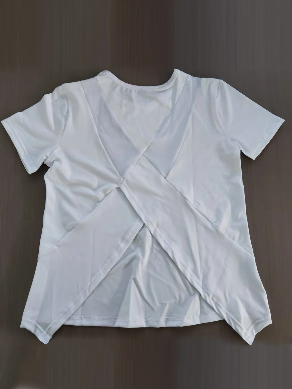 Black women's yoga outfit featuring a summer sports t-shirt from Corporación Turística, suitable for active wear and exercise.