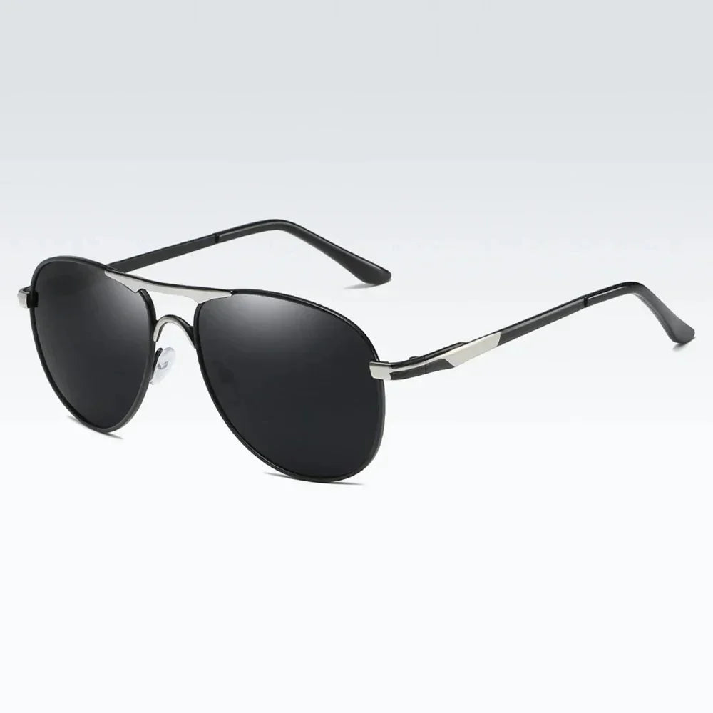 Luxury polarized sunglasses for men and women by Corporación Turística, featuring sleek black silver-gray frames and tinted lenses.