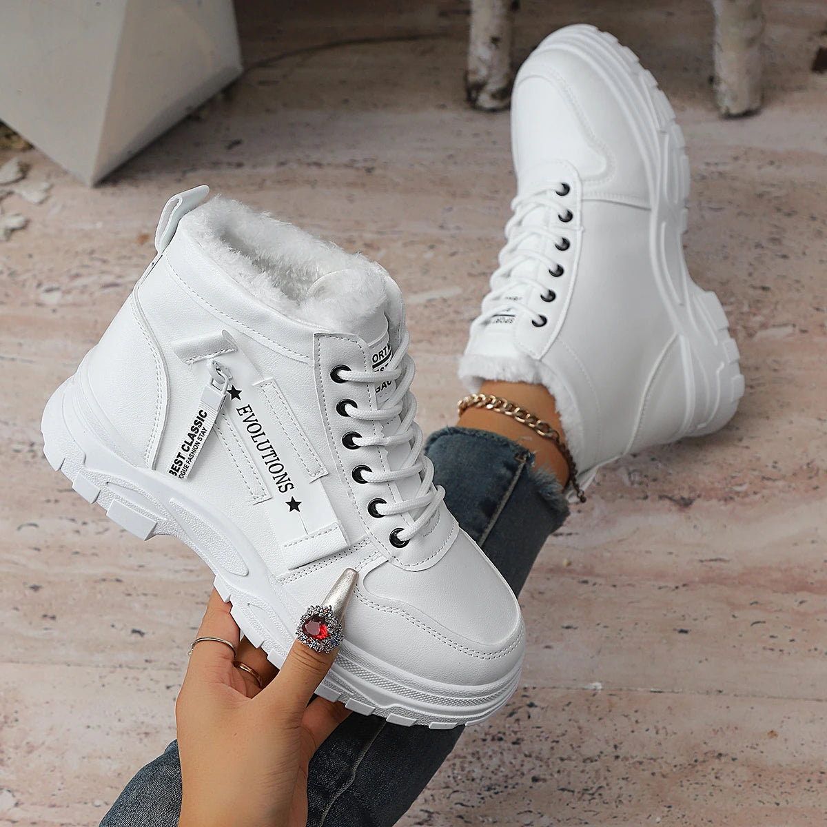 Pair of white winter boots by Corporación Turística, short thermal boots with a matte finish, suitable for cold weather.