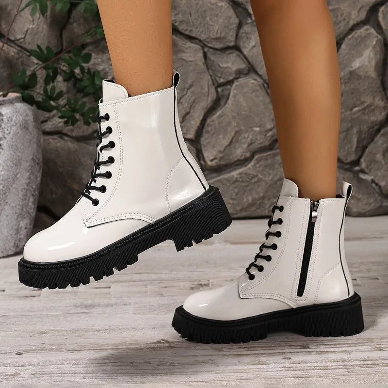 Pair of women's versatile ankle boots with a sleek design and white finish, ideal for casual or stylish outfits.