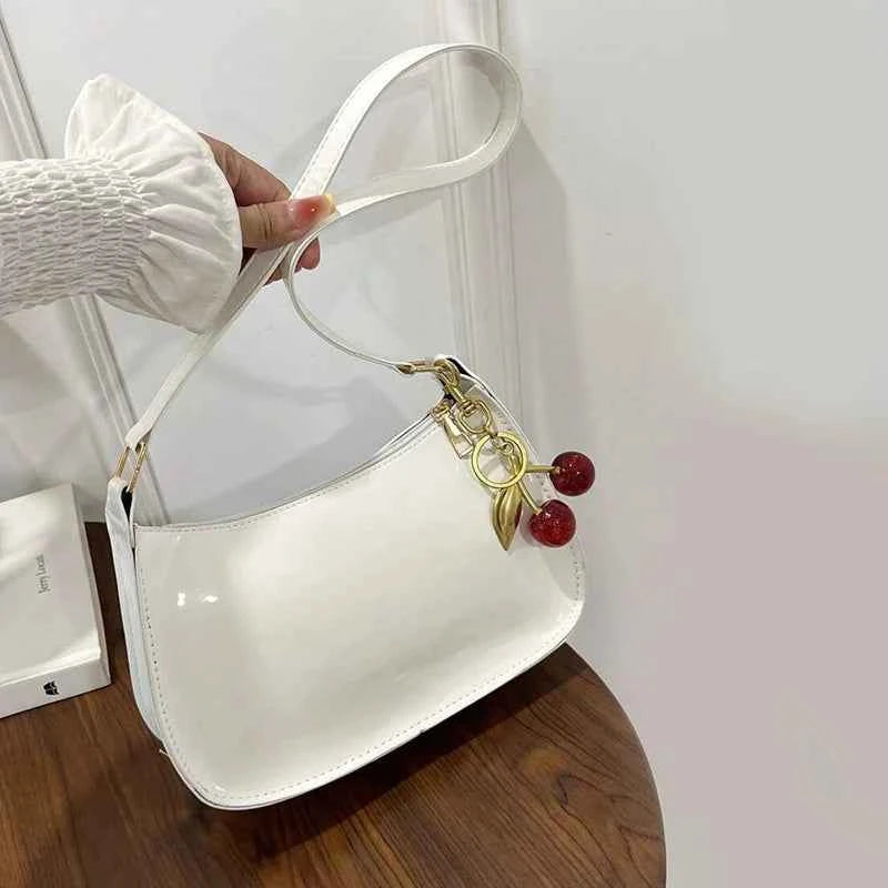 White synthetic leather women's handbag with shoulder strap, stylish and spacious, by Corporación Turística.