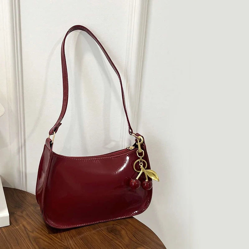 White synthetic leather women's shoulder handbag with top handle, stylish and versatile for everyday use.