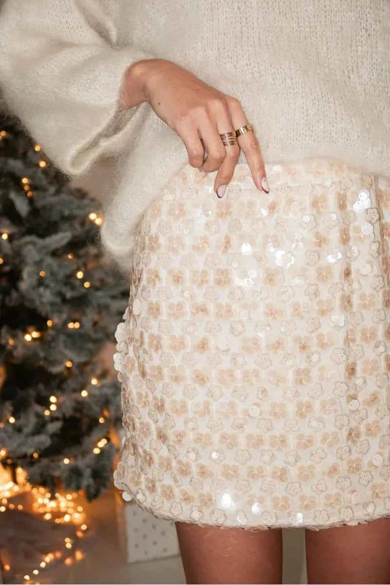 Brillante mini skirt with sequins for women, in a creamy white color, by Corporación Turística, shown with a smooth fabric finish.