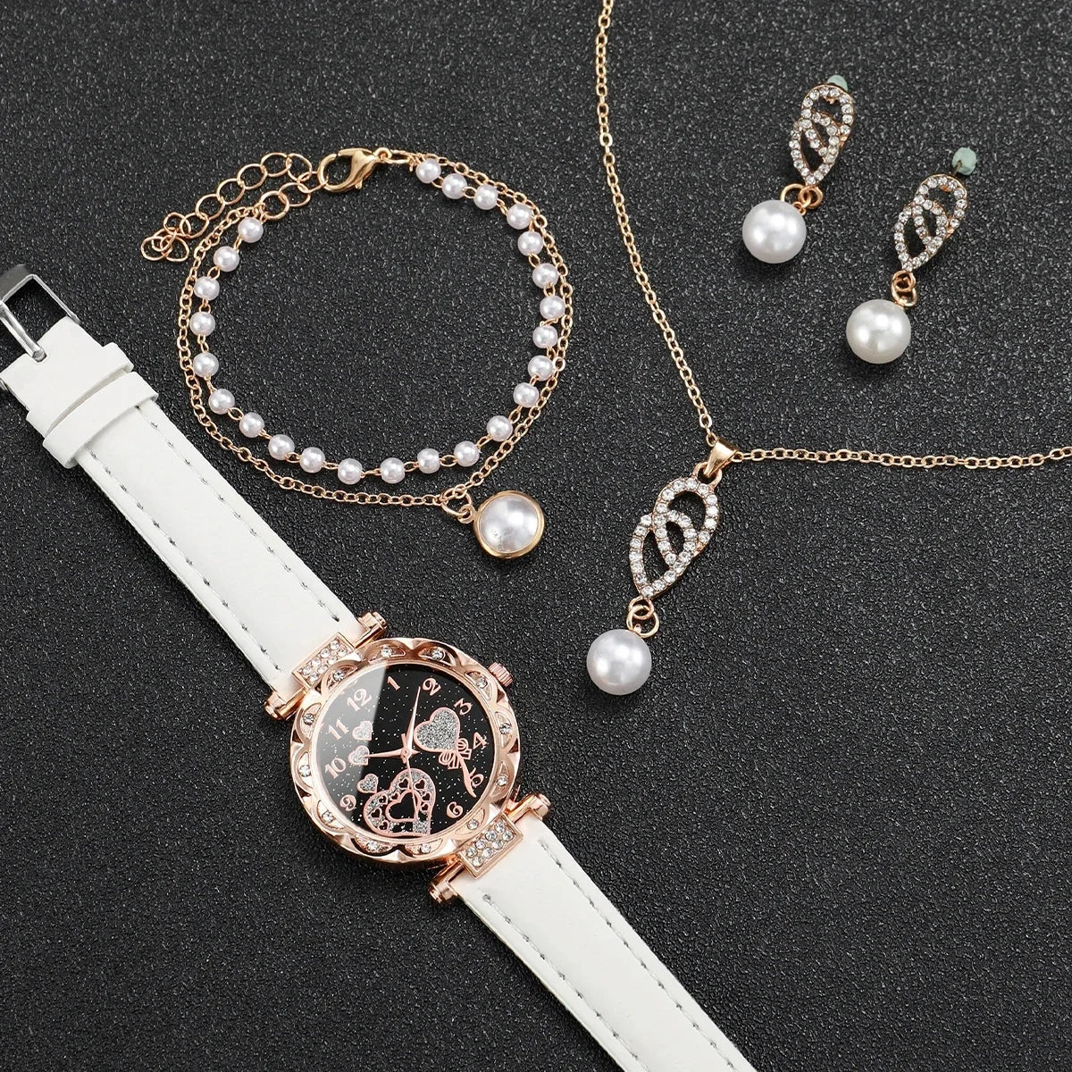 Set of four quartz wristwatches with diamond accents by Corporación Turística, featuring elegant white watch faces and sleek designs.