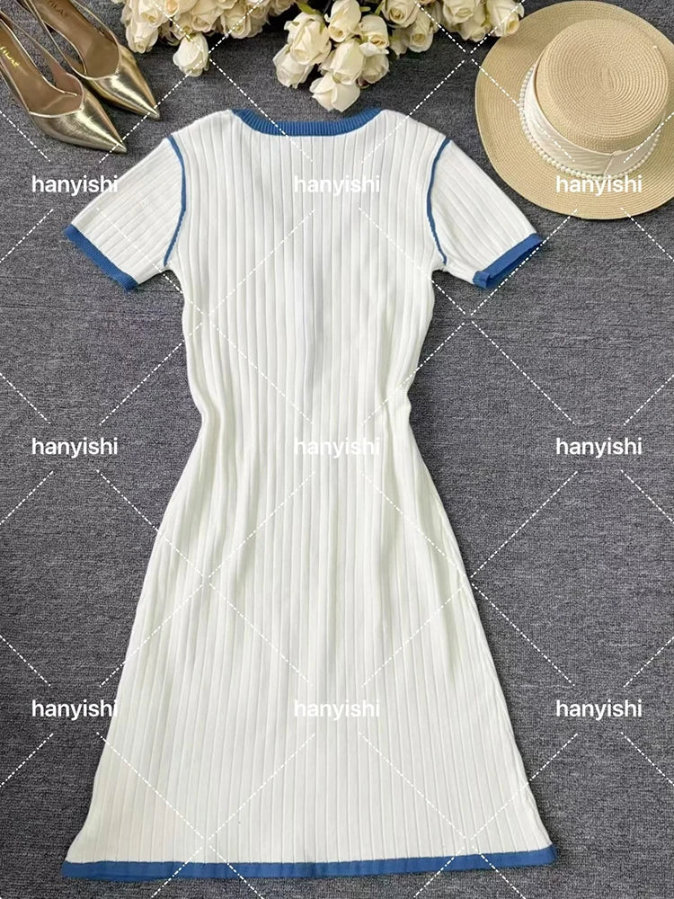 White women's mini dress by Corporación Turística, sexy knit dress with V-neck, fitted and stylish for casual or evening wear.