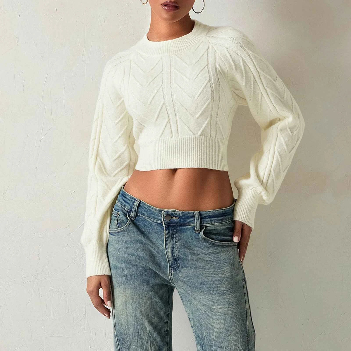 White women's cable-knit sweater by Corporación Turística, short-sleeve top with textured knit pattern.