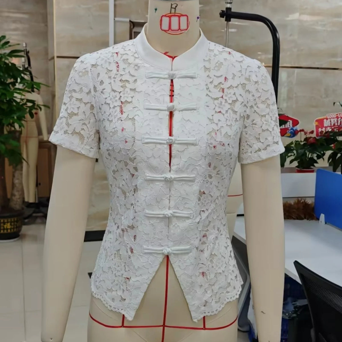 White women's summer short-sleeve shirt with collar from Corporación Turística, lightweight and casual for warm weather.