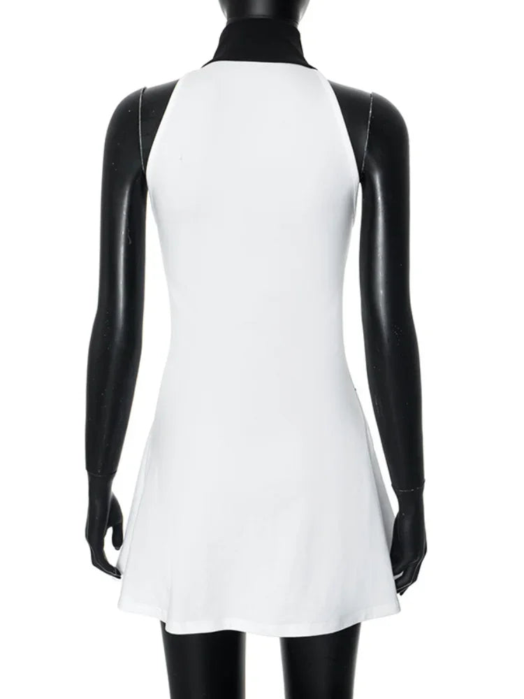 White empire waist dress with zipper and striped print by Corporación Turística, shown on a hanger.