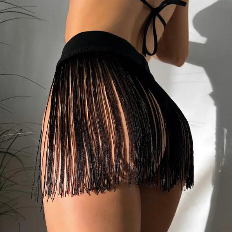 High-waisted sexy skirts with fringe and tassels from Corporación Turística, shown in white, featuring flowing fabric and stylish details.