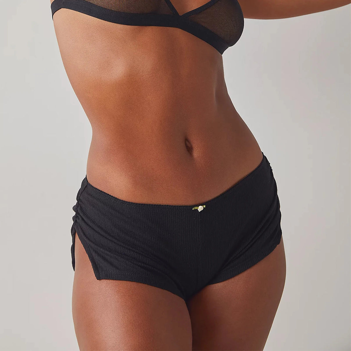 White women's shorts with side slits, made by Corporación Turística, featuring a stylish open side design.