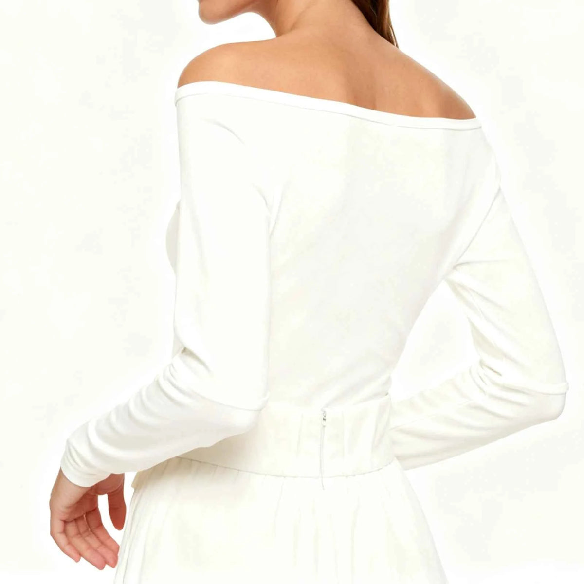 White women's irregular crop top for yoga, exercise, and sports by Corporación Turística, shown on a plain background.