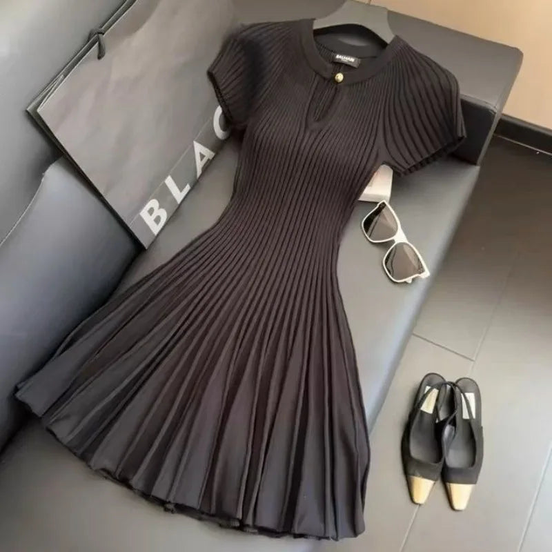 Elegant black knit dress by Corporación Turística, showcasing a stylish, fitted design perfect for fashionable occasions.