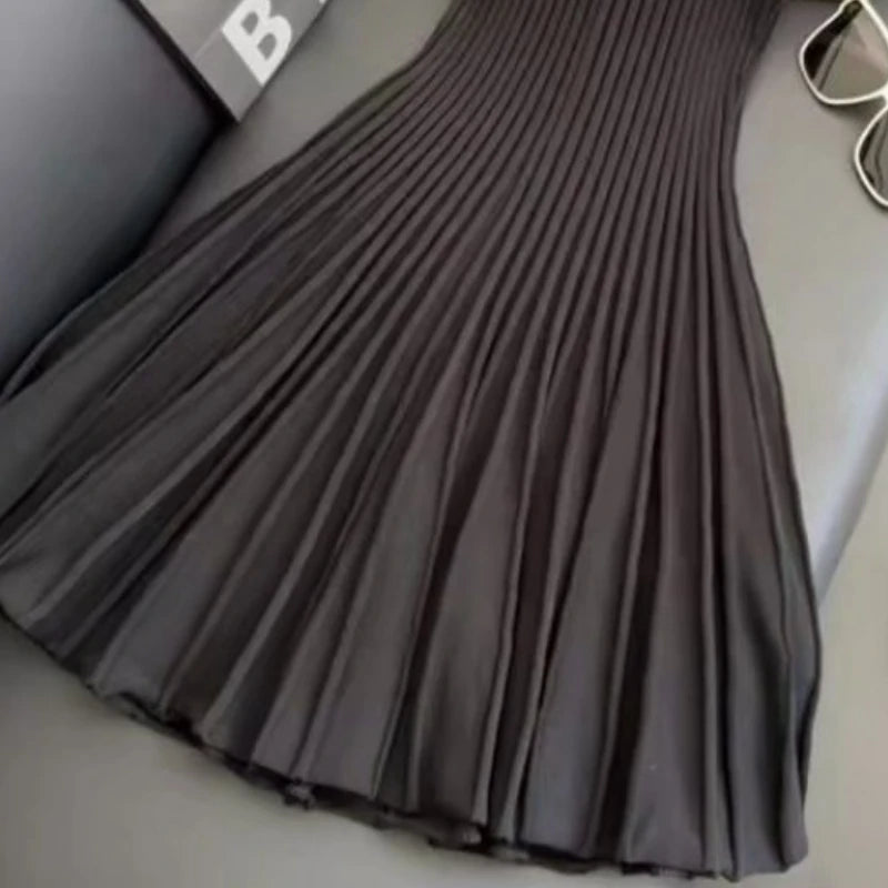 Black knit dress from Corporación Turística, elegant and fashionable, shown in size XL on a white background.