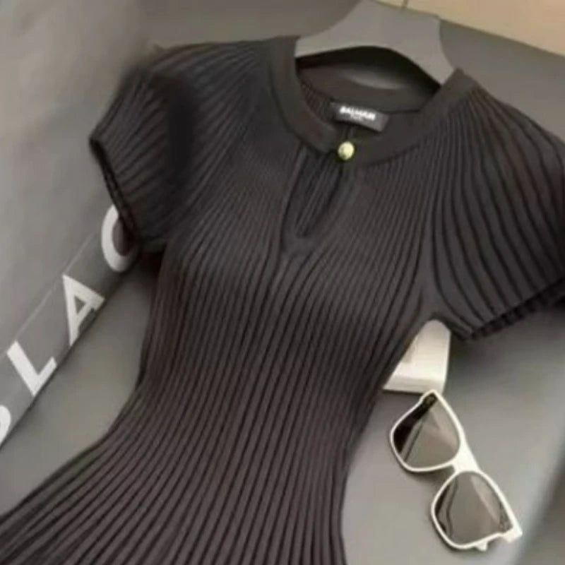 Black knit dress by Corporación Turística, elegant and stylish, displayed in white XL size on a model.