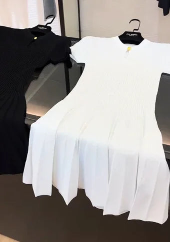 Black knit dress by Corporación Turística, elegant and trendy, shown in white XL size with a stylish fit and modern design.