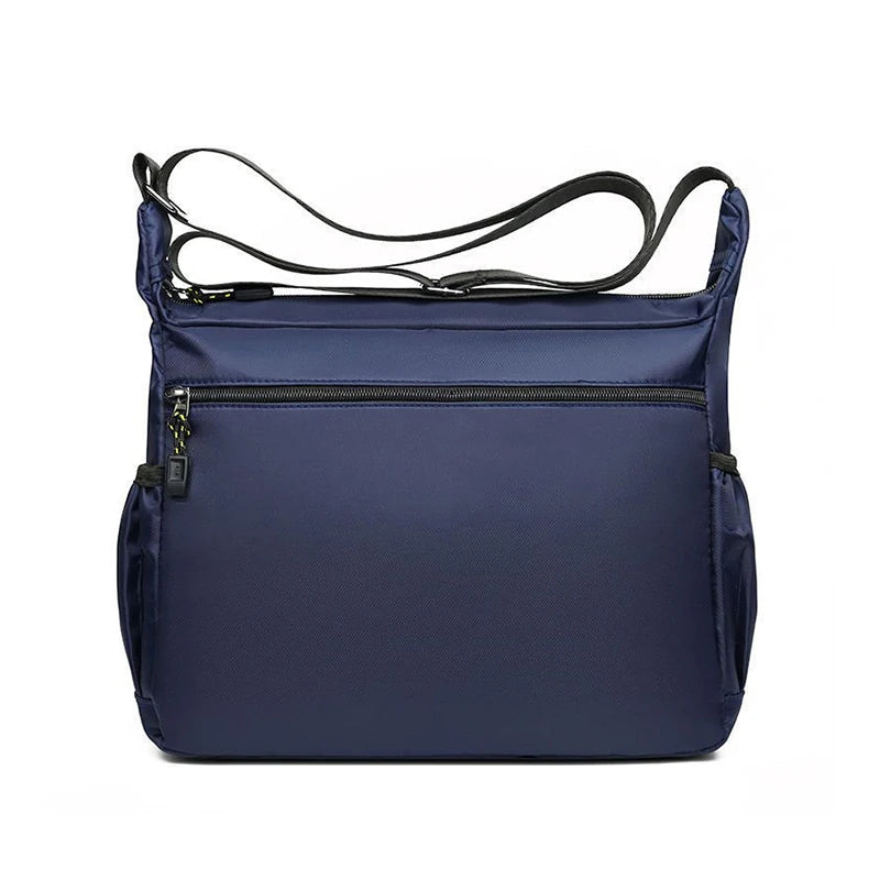 Black nylon men's shoulder bag with multiple layers, ideal for business travel, from Corporación Turística.