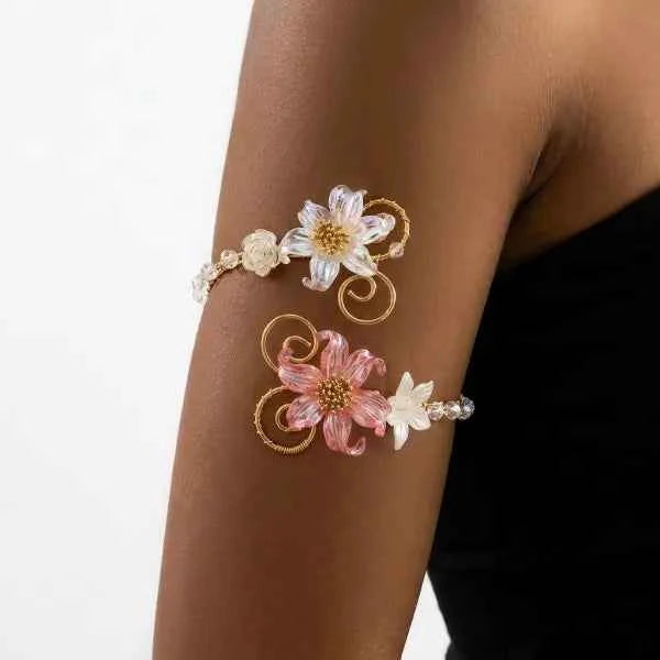 Open multicolored floral bracelet by Corporación Turística with hollow flower designs, stylish and vibrant jewelry accessory.