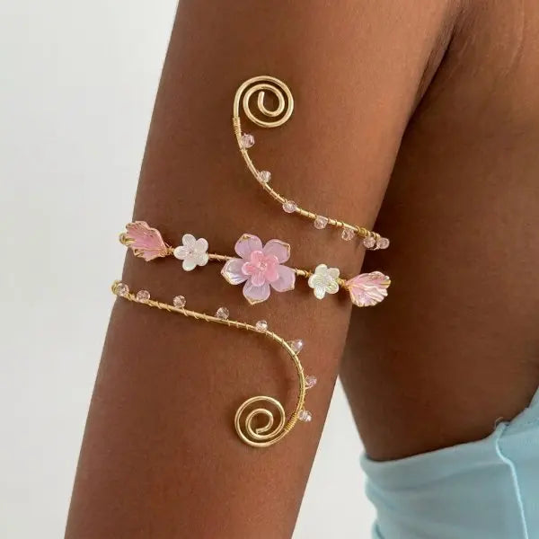 Open multicolored floral bracelet from Corporación Turística featuring hollow floral designs, vibrant and eye-catching jewelry accessory.