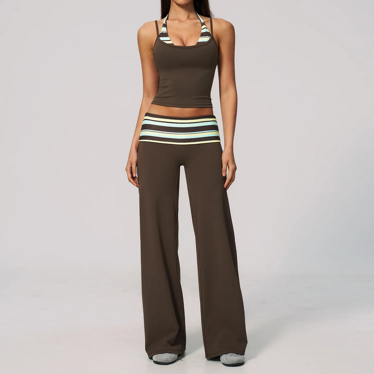 Brown dotted 2-piece yoga set for women, sporty athletic clothing by Corporación Turística, includes top and leggings.