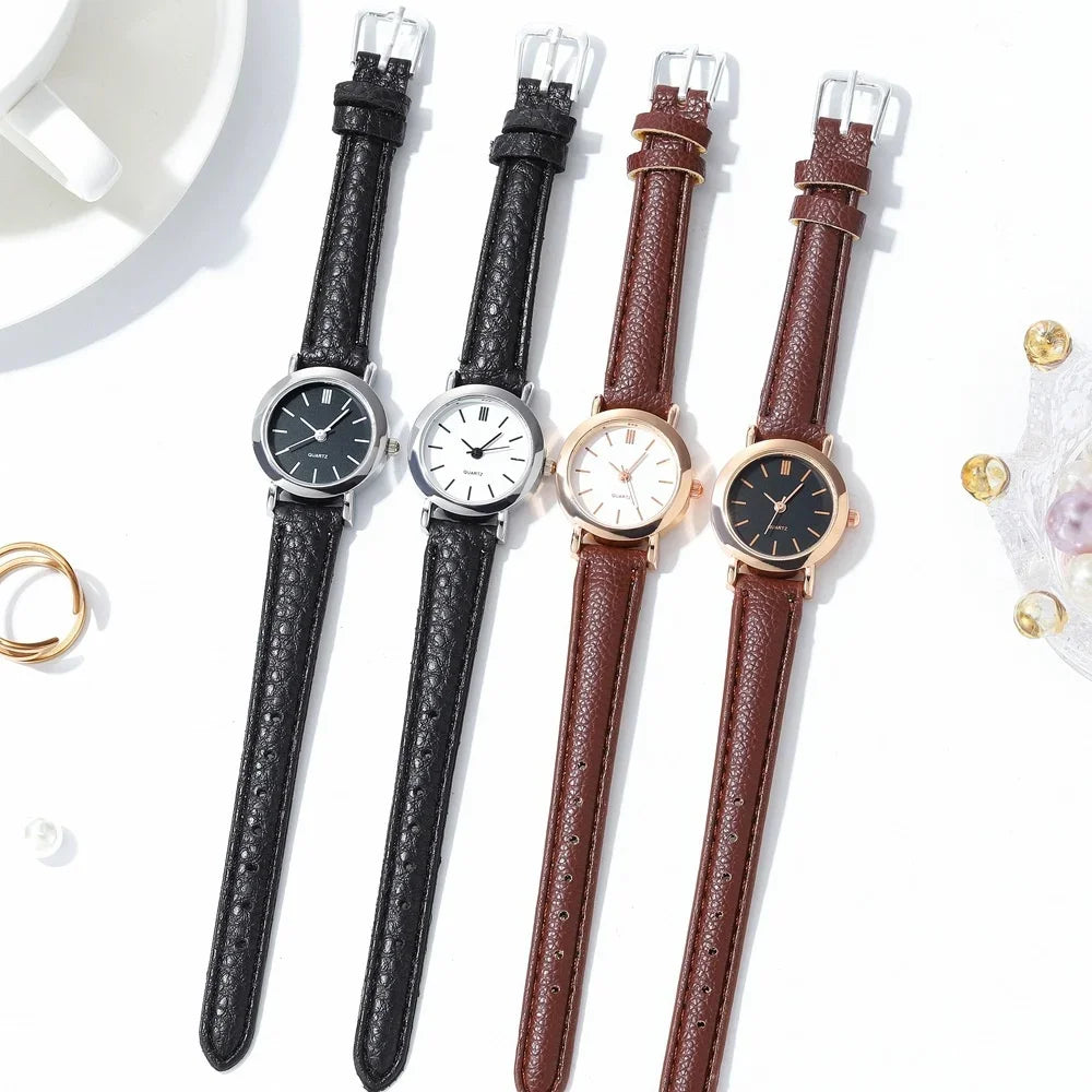 Minimalist women's quartz watch with white dial and brown strap by Corporación Turística, featuring a sleek, elegant design.